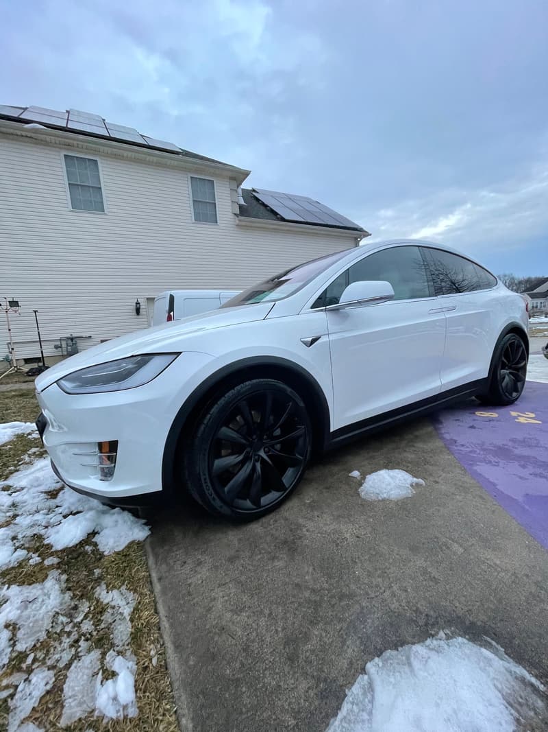 White Tesla Model X detailed on a snowy winter driveway